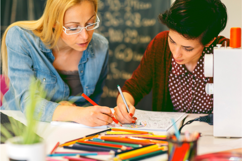 two women doing adult coloring