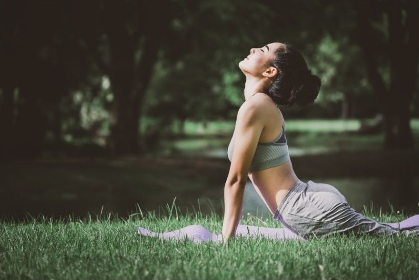 woman doing yoga outdoors